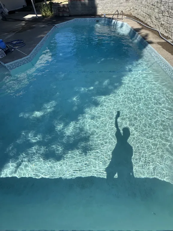 Clear finished pool photographed from a phone on site